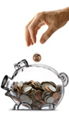Hand putting money into piggy bank
